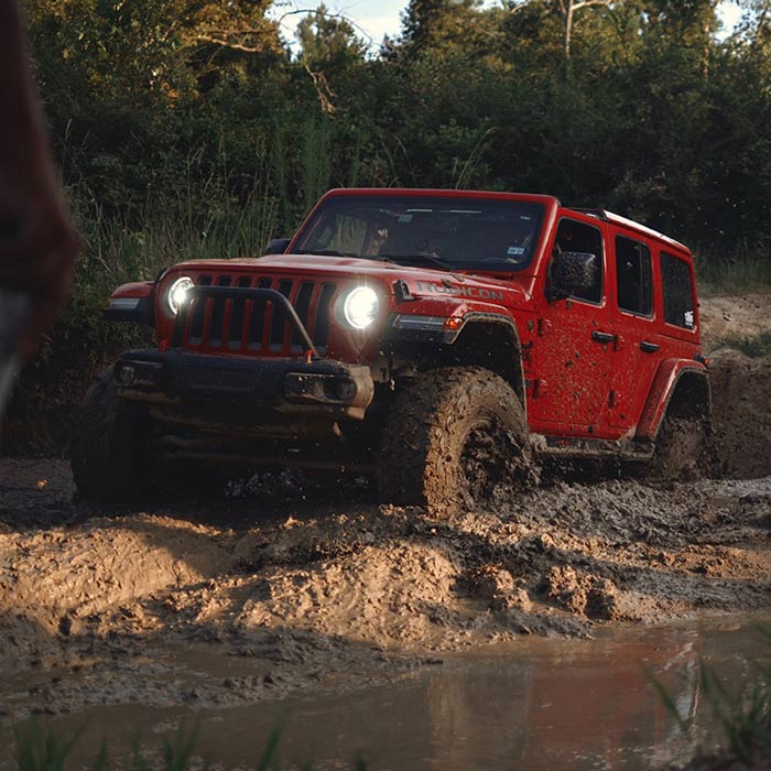 jeep driving through mud