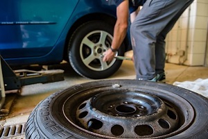 a mechanic fixing car tyre