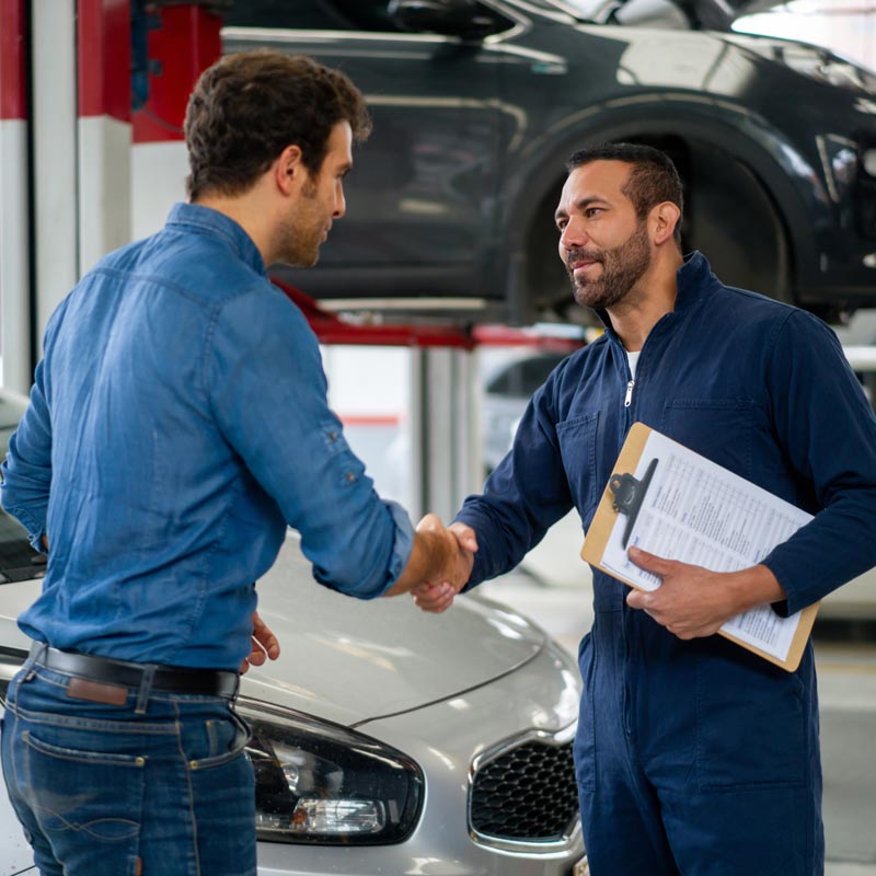 mechanic shaking hands with client