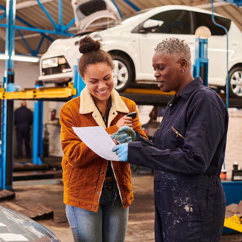 woman talking to mechanic