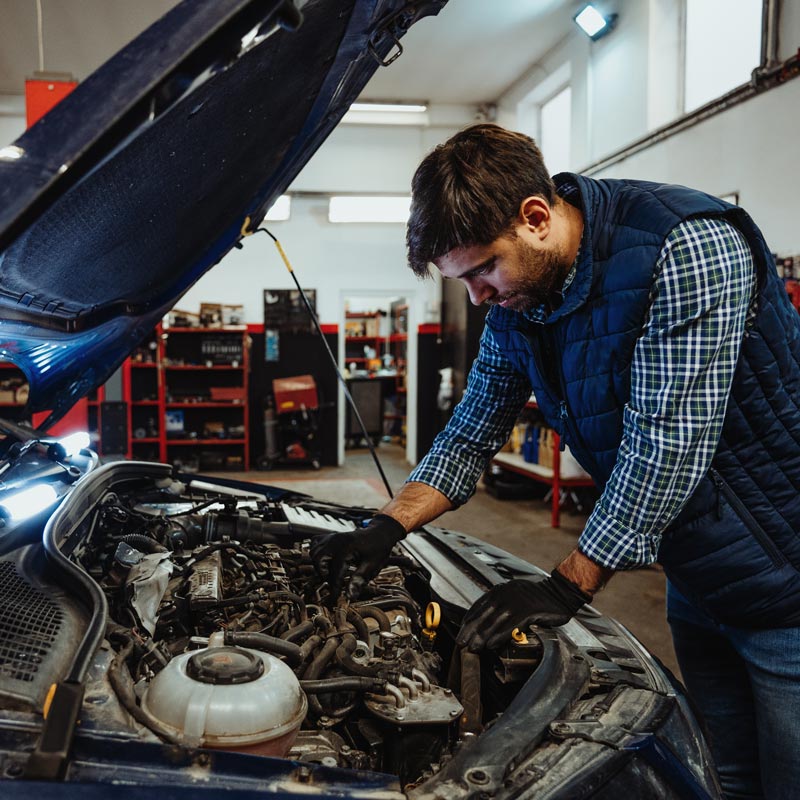 mechanic looking at car engine