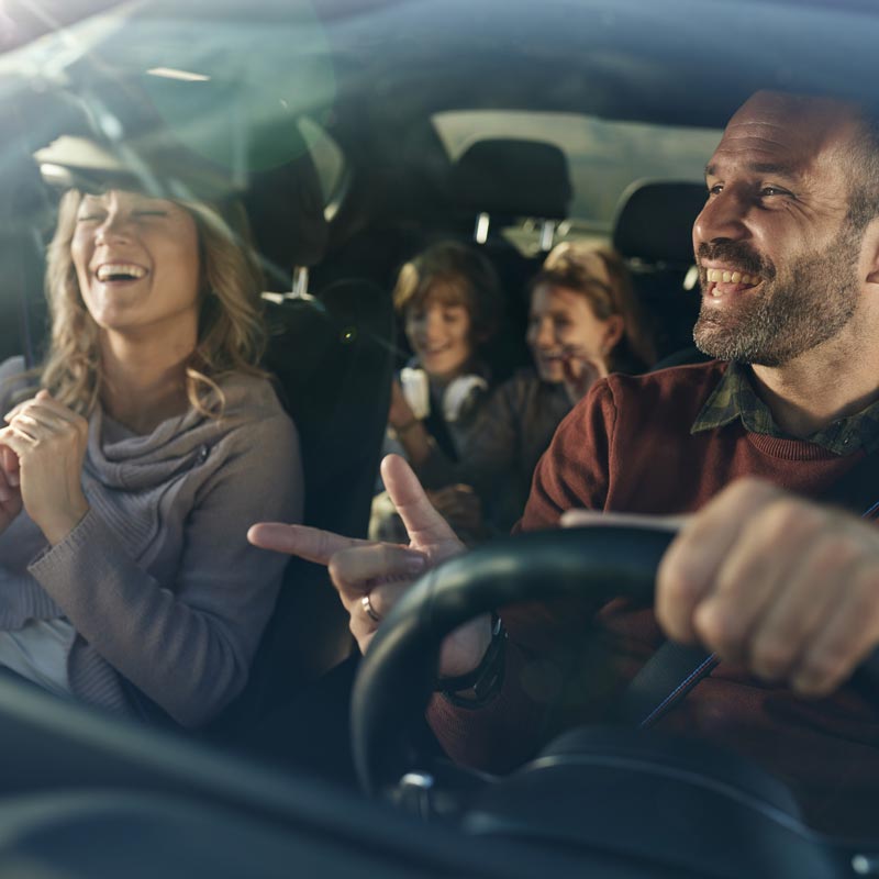 family of four driving in car